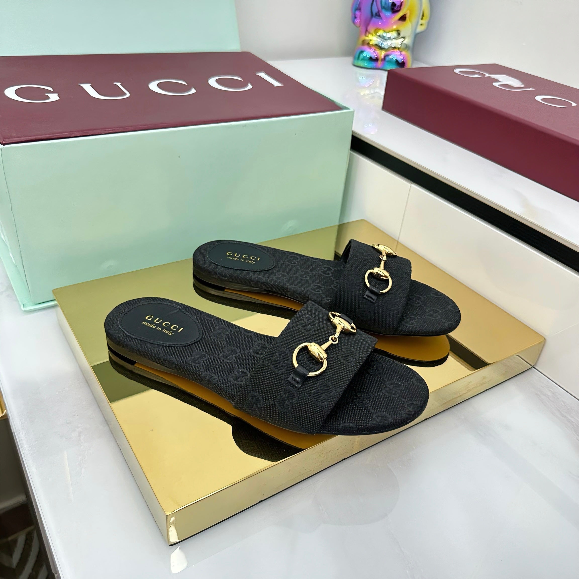 GUCCI SLIDES IN BLACK WITH GOLD HARDWARE