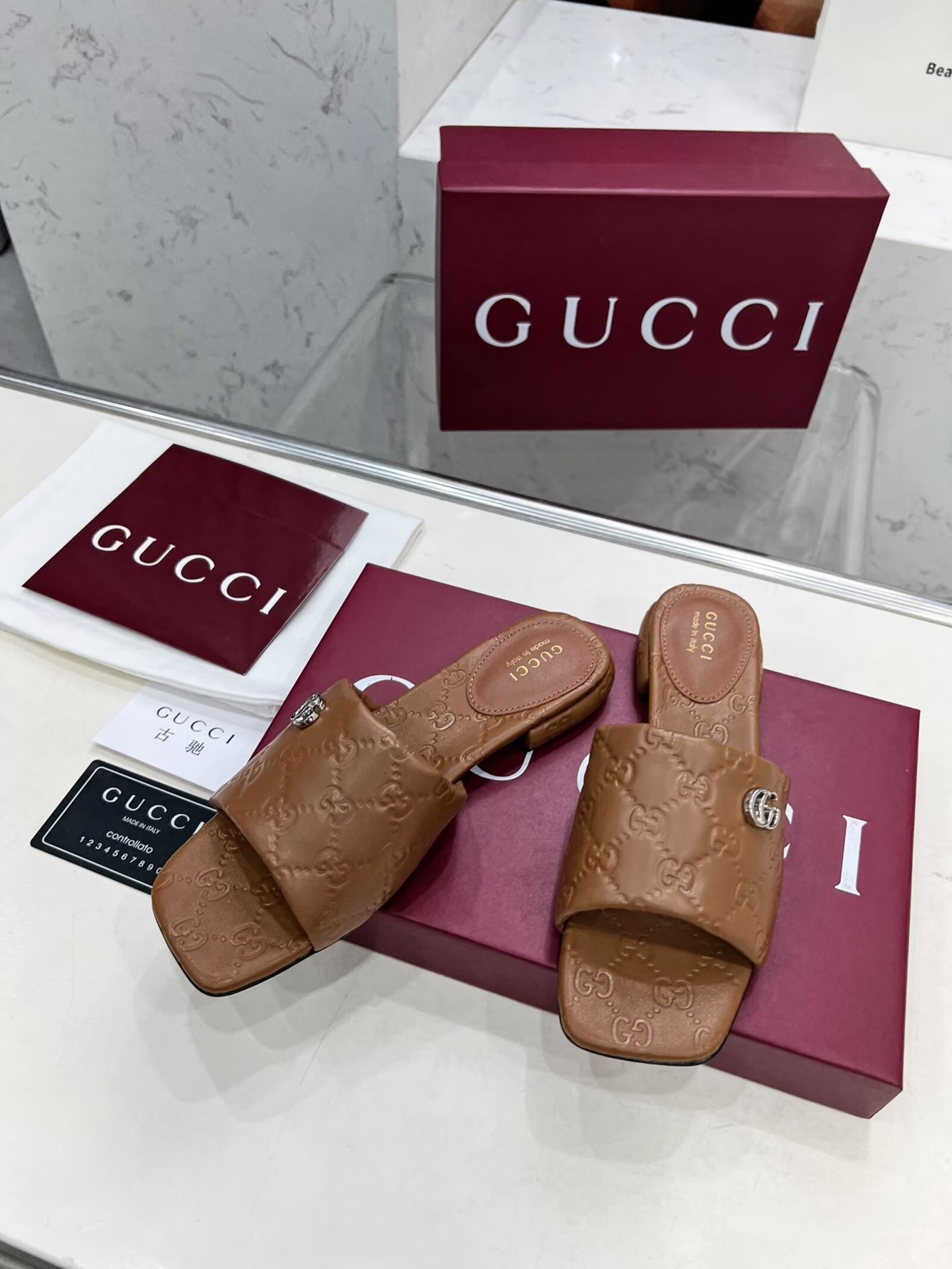 GUCCI CASUAL SLIPPERS IN BROWN CALFSKIN LOGO EMBOSSING